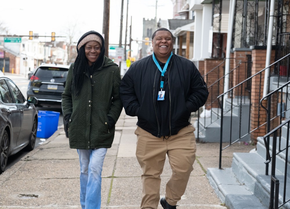 two people walking down the street